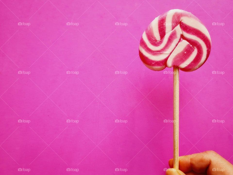 white and fuchsia lollipops on a fuchsia background