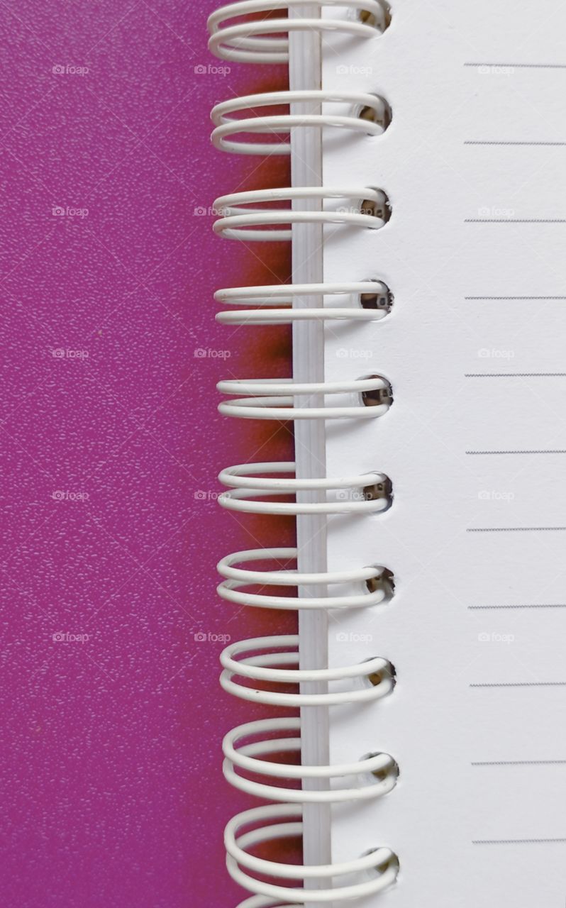 Book with wire binding in purple background....