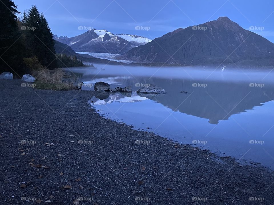 Twilight Reflection on Mendenhall lake.   Fog line separating frigid water and glorious mountains surrounding the Mendenhall Glacier.  