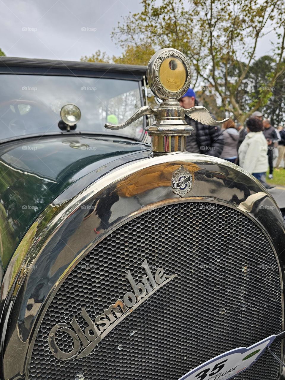 "Never old Oldsmobile" Antique, well preserved, shinning and beautiful Oldsmobile seen from the front.