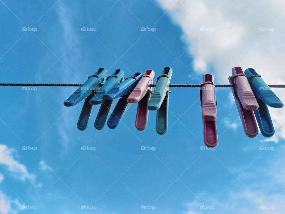 hanging clothespins against the blue sky.