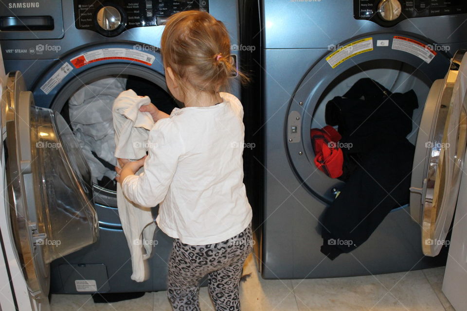 Young girl helping with laundry