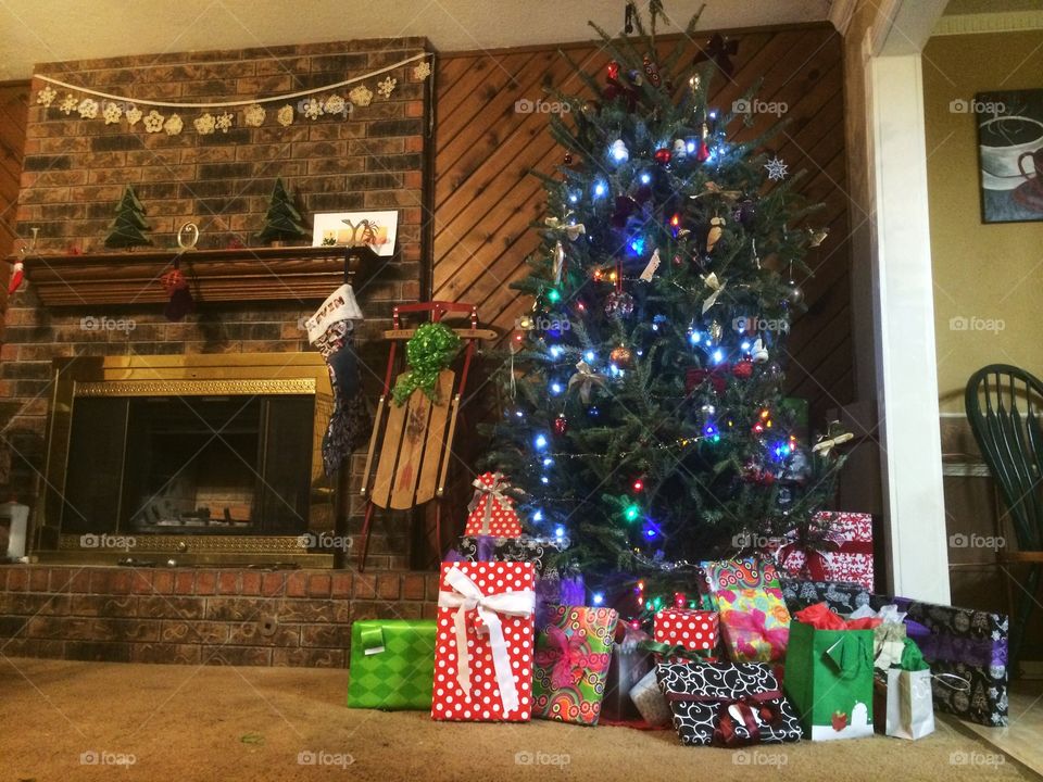 Christmas . Christmas tree, presents, and fireplace on Christmas Eve. 