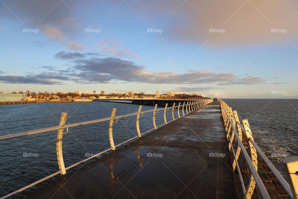 Breakwater on a rainy day , rainbow on the sky