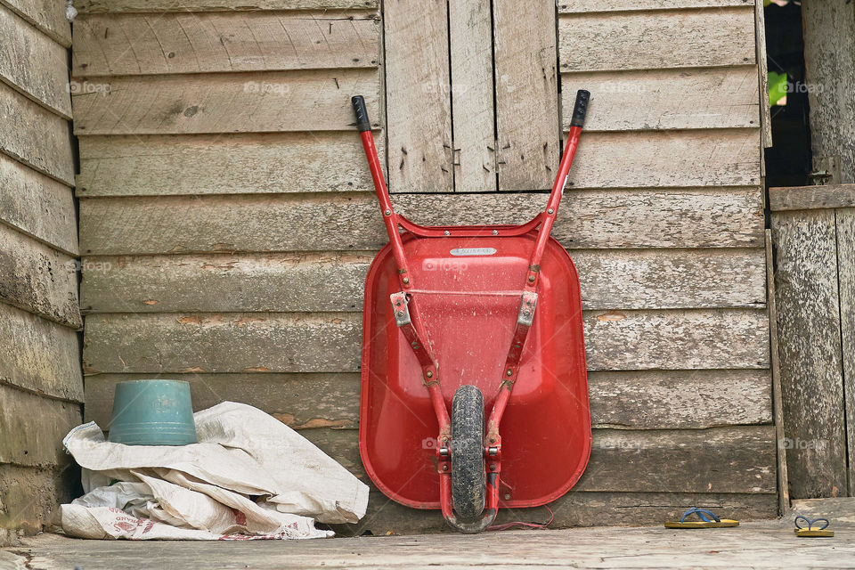 farm red cart in front of farm hut