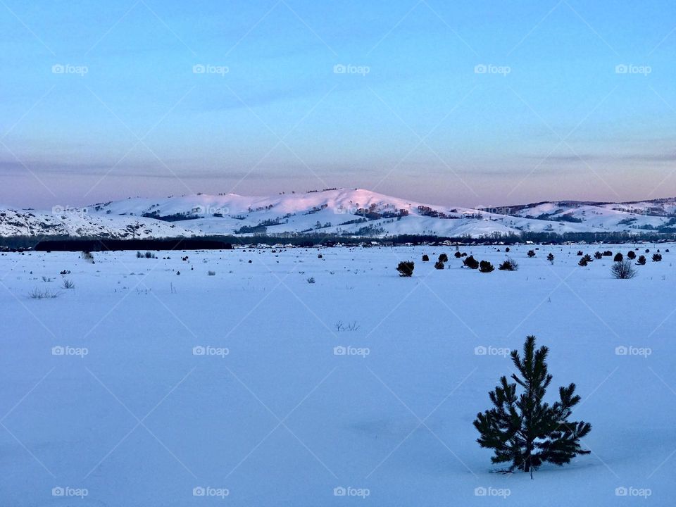 Winter landscape at sunset 