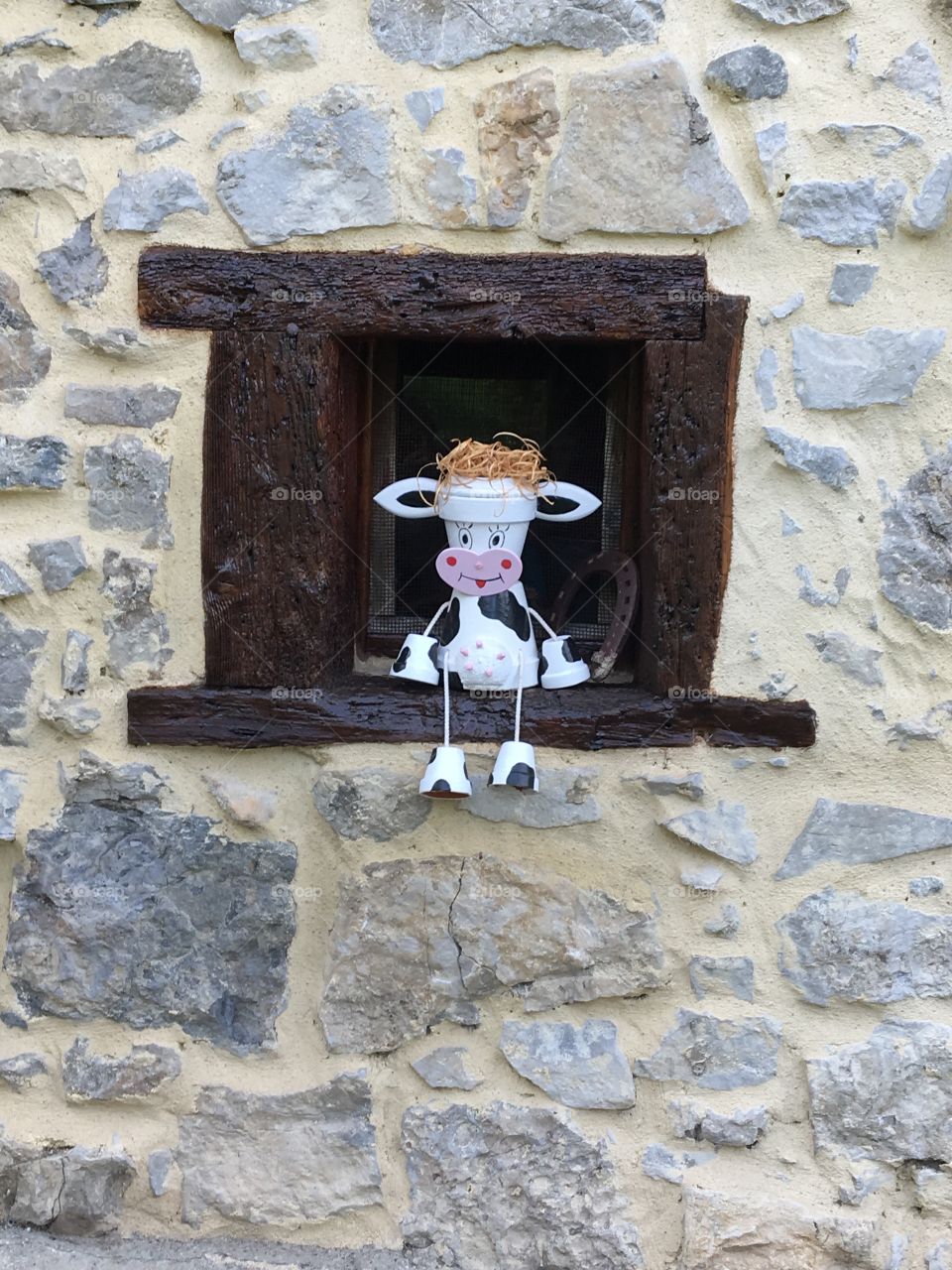 Little window with handcrafted smiling cow