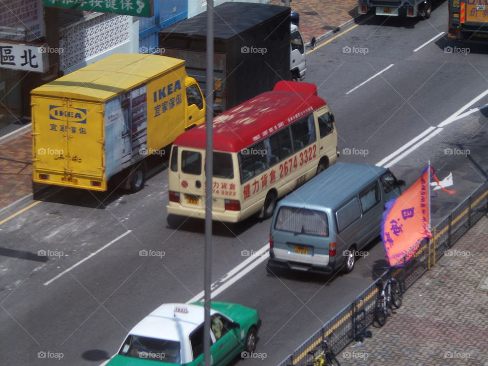 Red Toyota Coaster minibus and traffic from high up 