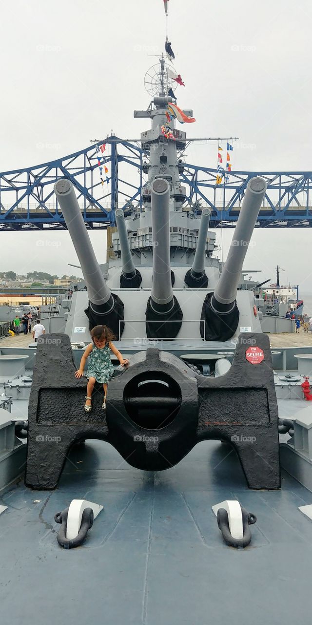 young child exploring the battleship