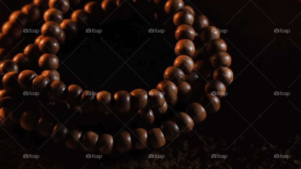 Wooden prayer beads in dim light