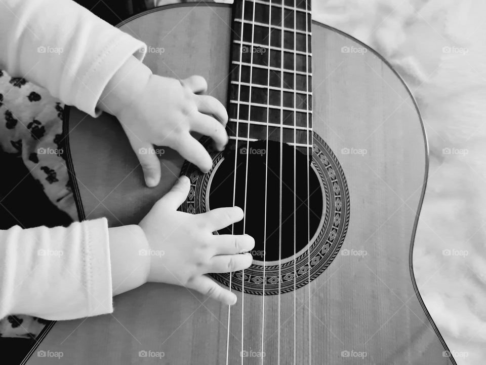 guitar and baby hands