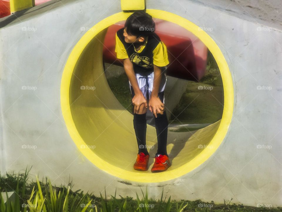 A boy in the yellow tunnel...