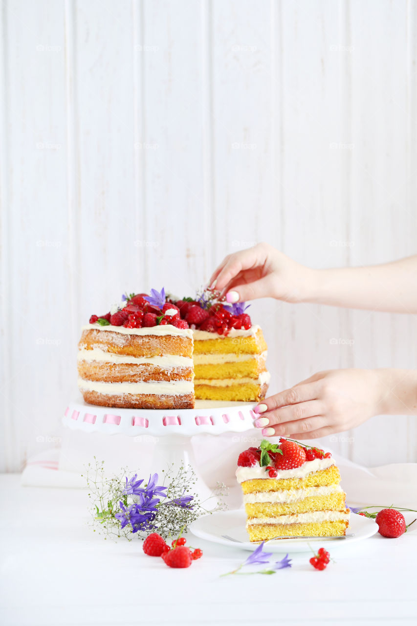 Tasty cake with berries on stand
