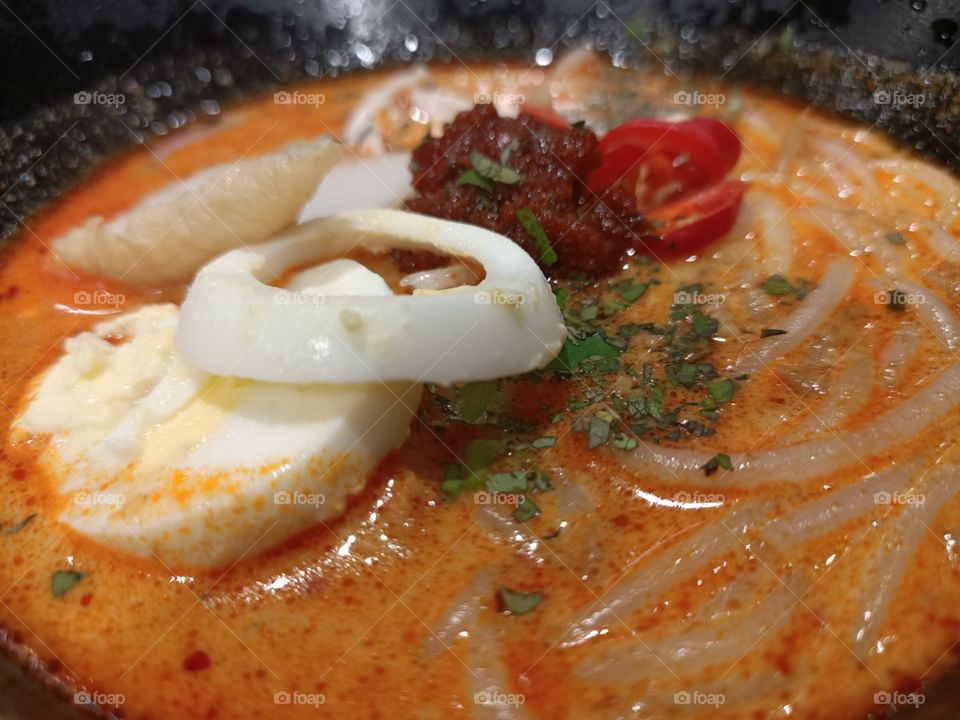 Laksa - A Peranakan dish from Asia.  Thick noodle in spicy curry coconut milk.