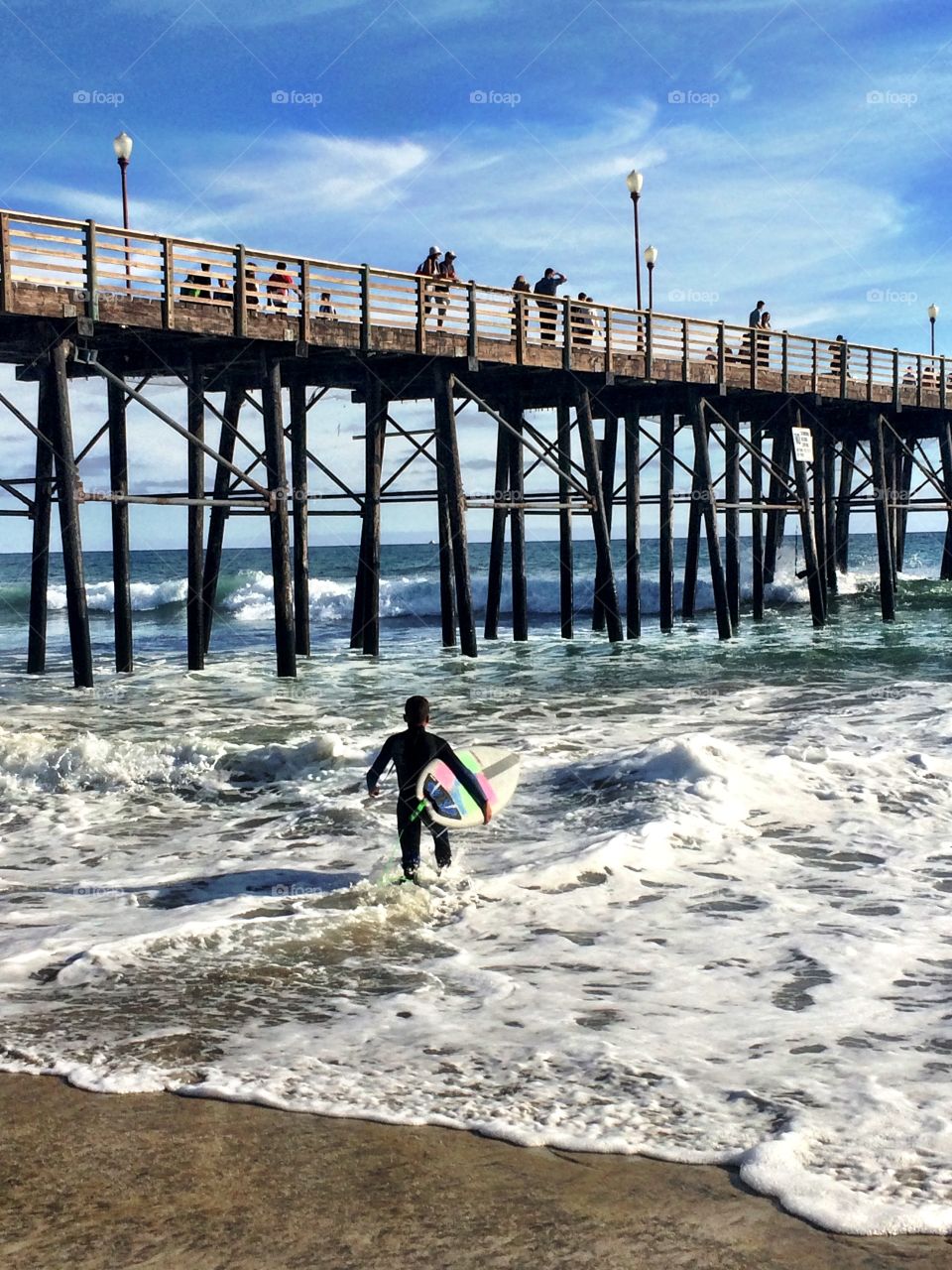 Young Surfer Heading In. Oceanside Pier