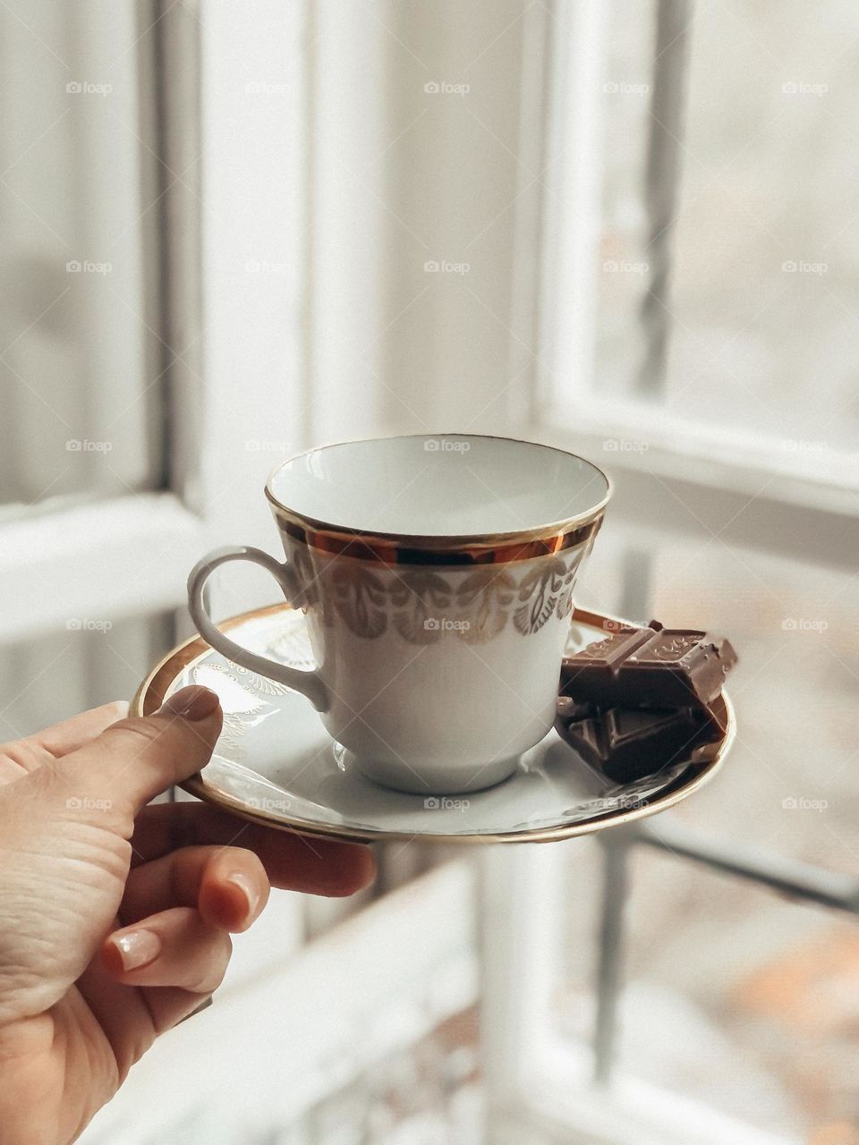 Coffee cup with saucer in hand vintage pottery 