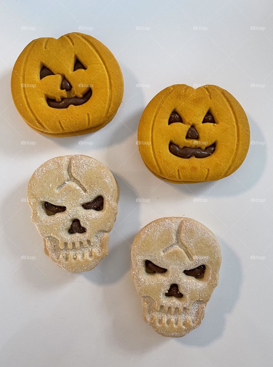 Halloween cookies in the shape of pumpkins and skulls 