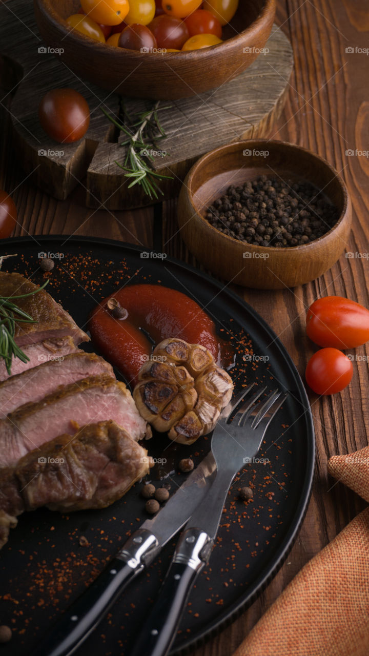 bacon steak on a dark background