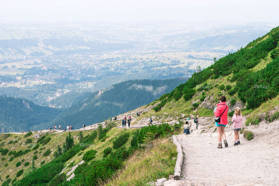 Woman and little girl on mountain trail