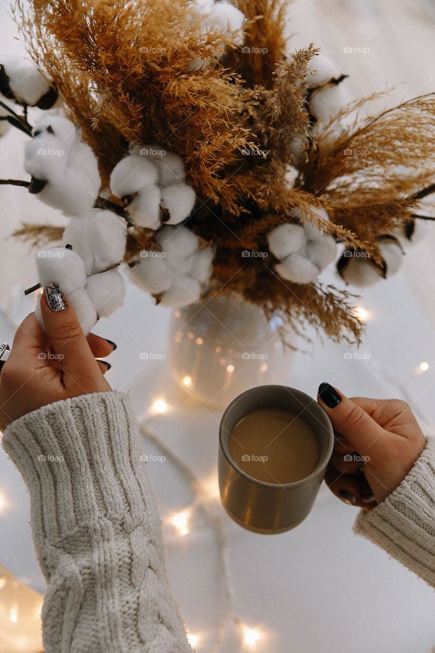 Hands and cup of coffee. New Year atmosphere