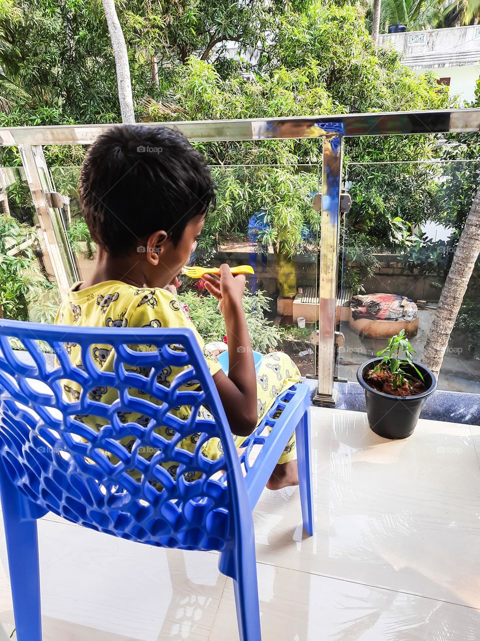 Kid having snack in his favorite balcony