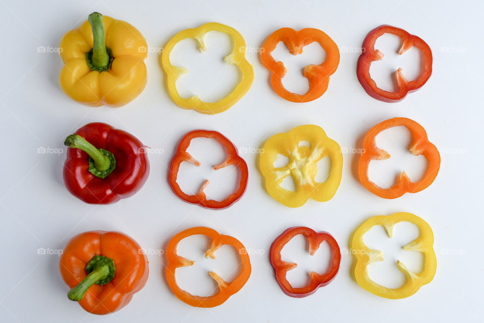 Sweet peppers in rows and slices