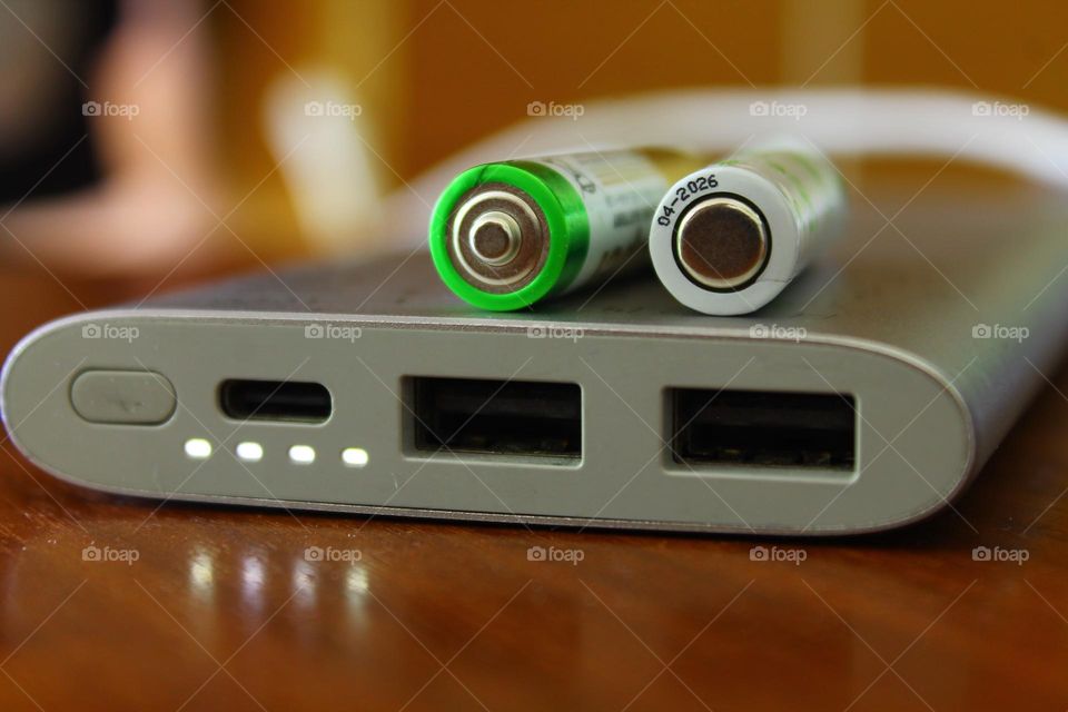 on the table is a fully charged power bank with a burning charging indicator