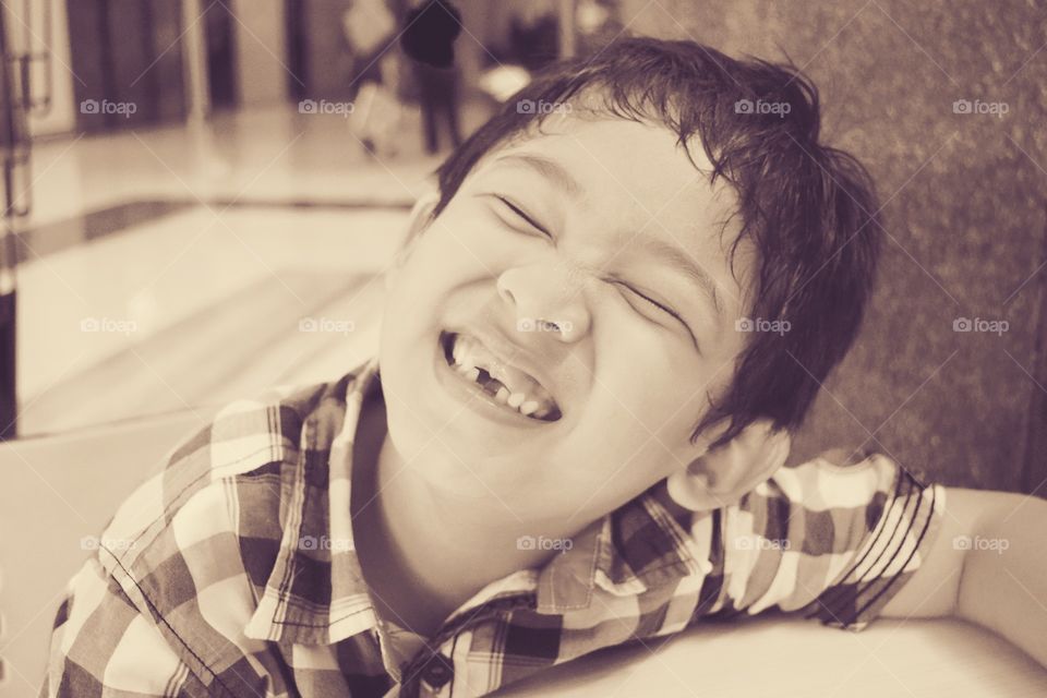 Young boy smiling with broken teeth
