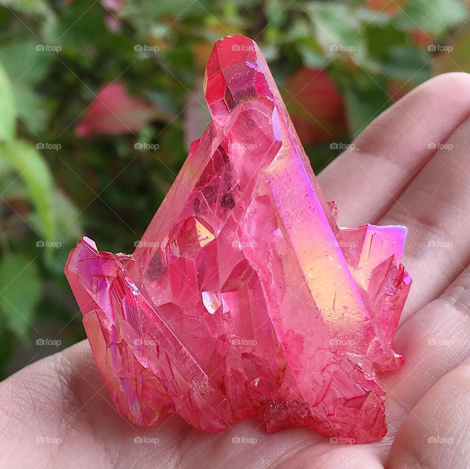 A pink aura quartz crystal cluster.