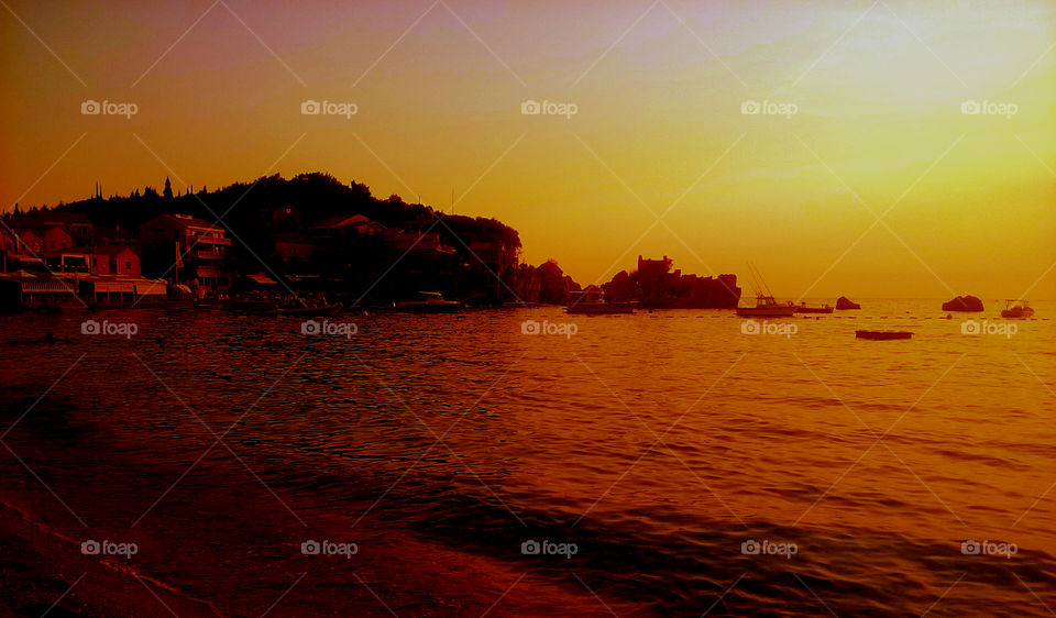 amazing city, orange sunset, beach and sea.