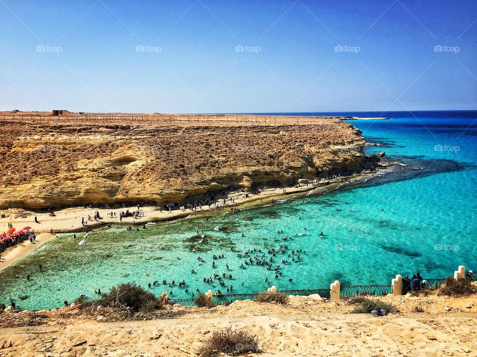 The magnificent nature of the Sea of Matrouh in the area of Ajiba, where the mountains embrace the sea and the waves break into the gorge in a wonderful landscape