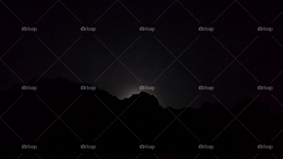 The Moon behind a mountain