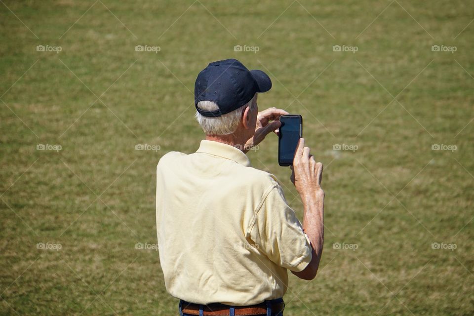 Senior man holding smartphone 