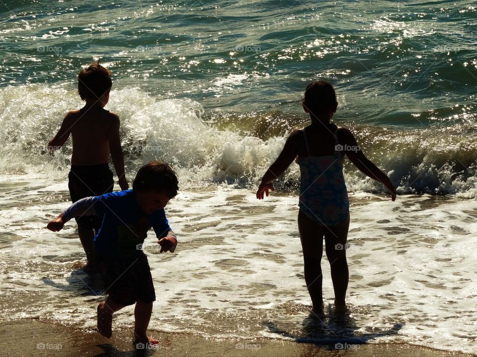 Children at play in ocean surf