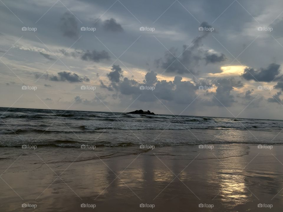 Its bentota beach in an evening with the sunset and little bit of rainy clud