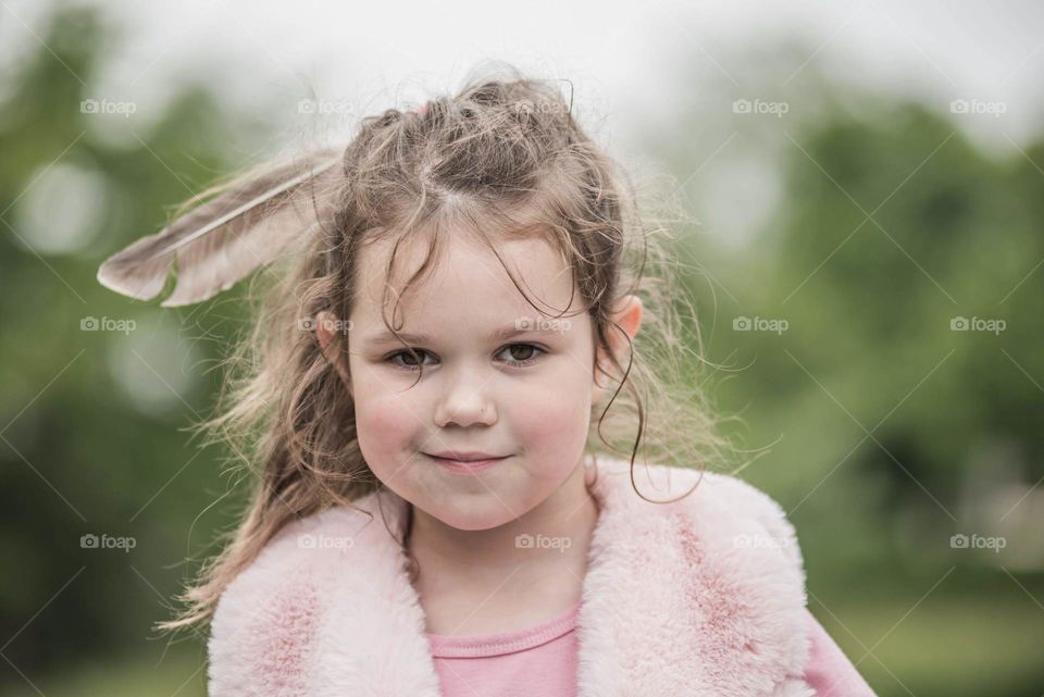 A girl with a feather in her hair 