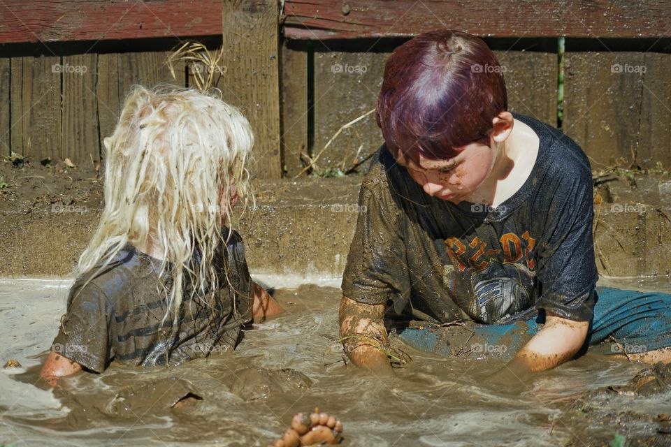 Kids Playing In Mud