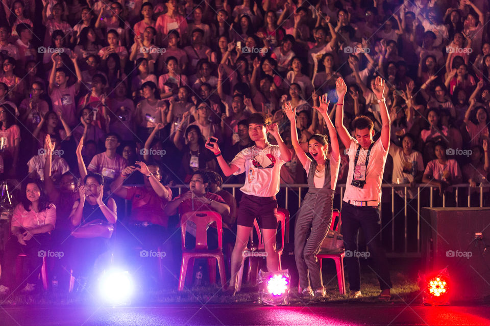 Audiences dancing in the night concert