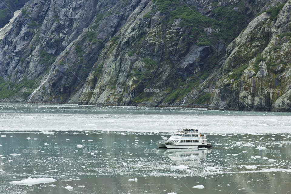 Boat near a glacier in Alaska show us how small we are near nature 