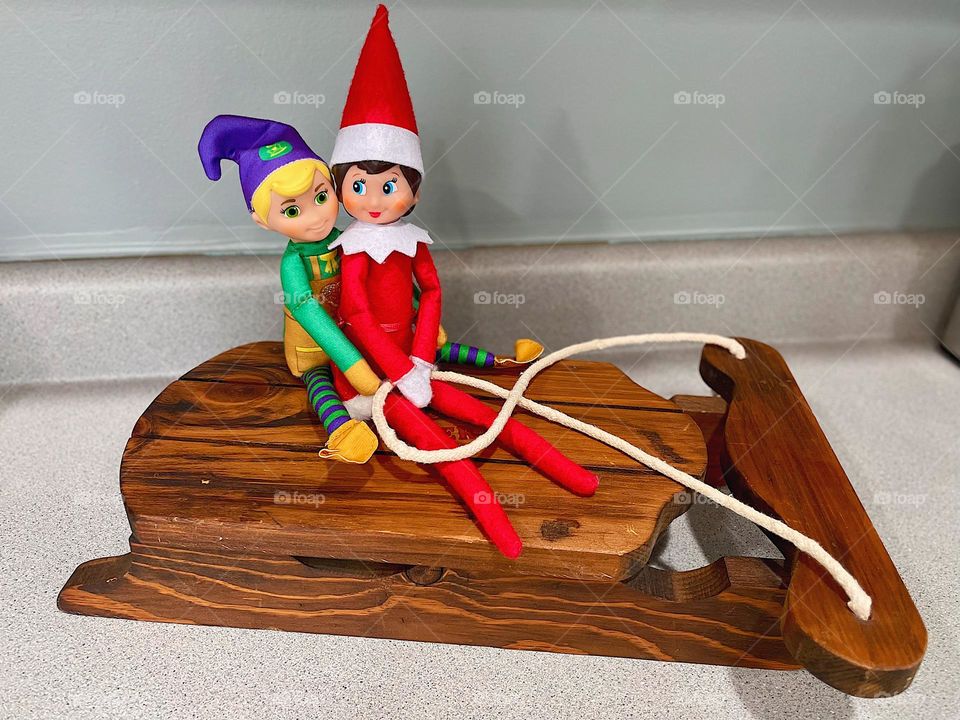 Elves riding a sled, elf on the shelf antics, silly entertainment for kids, elf on the shelf daily poses