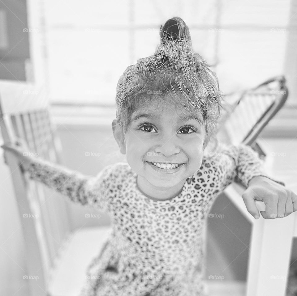 Little girl smiles for the camera, black and white portrait of a toddler, toddlers smiling for the camera, posing for a picture, monochrome kids photos