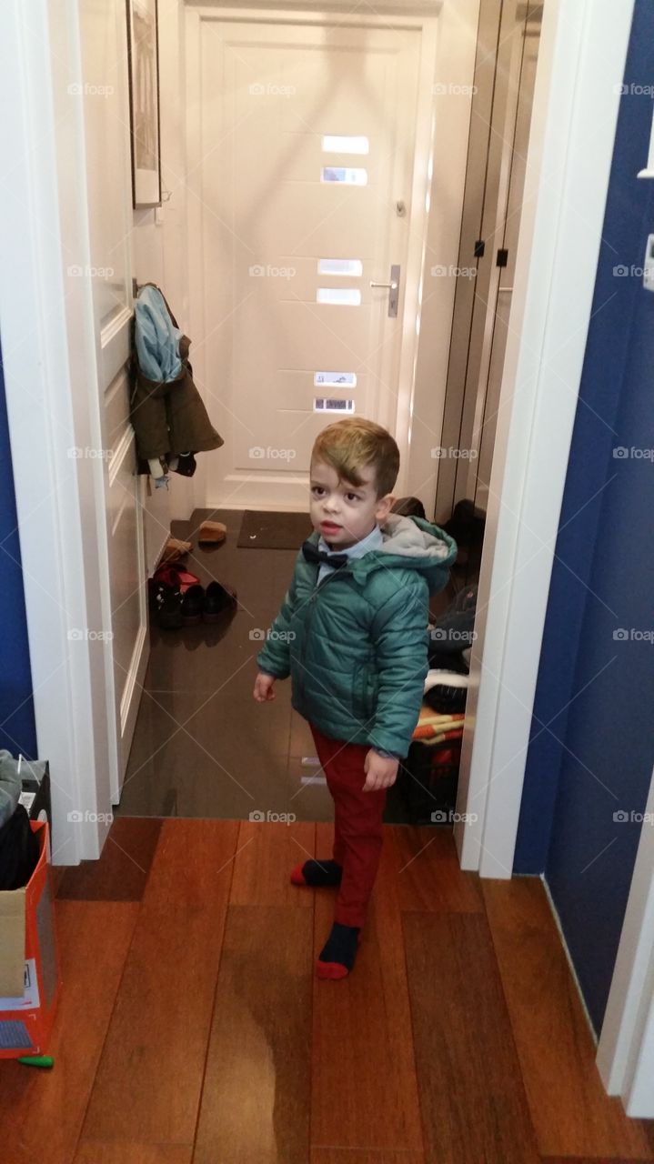 Cute little kid standing in house
