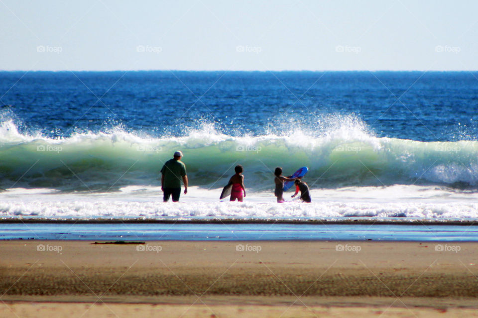 Summertime is time to go to play in the waves! Whether its surfing or just boogie boards we all love to play in the water! This day was spectacular and we spent all day riding the waves with short stops to refuel with our laden picnic basket.