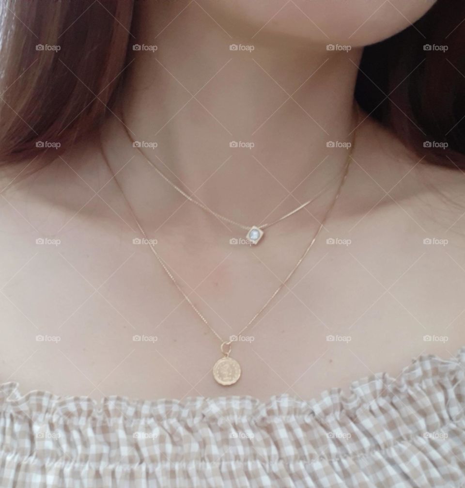 Beautiful necklaces on woman's neck. Close up