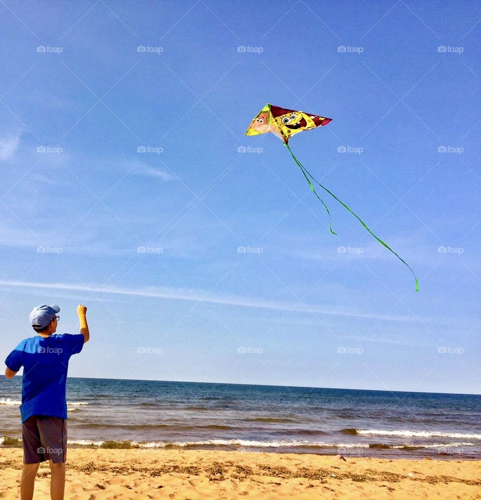 My son flying a kite at Red Point beach on Prince Edward Island.