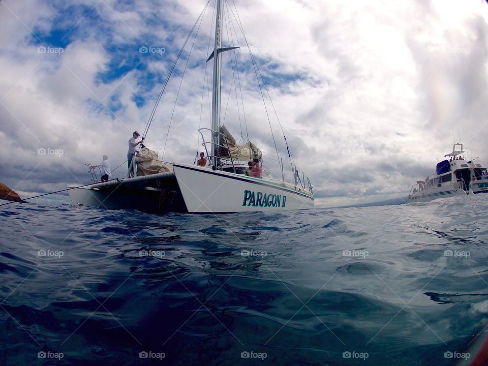 On the ocean sailing in paradise. Sail boat in bay in Maui Hawaii