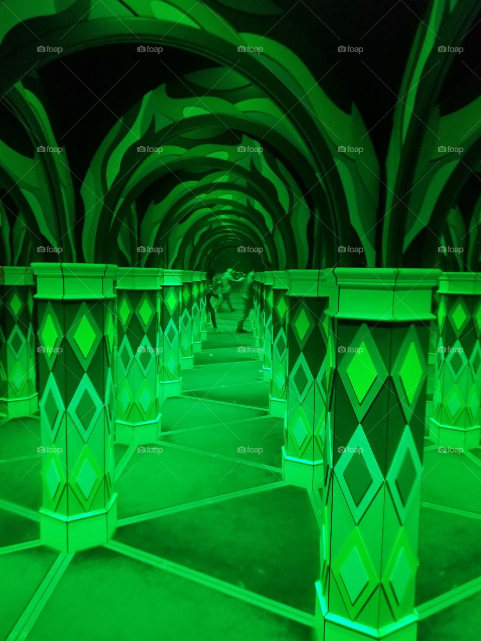 Electric green lights of crazy mirror maze confusion with random patterns throughout