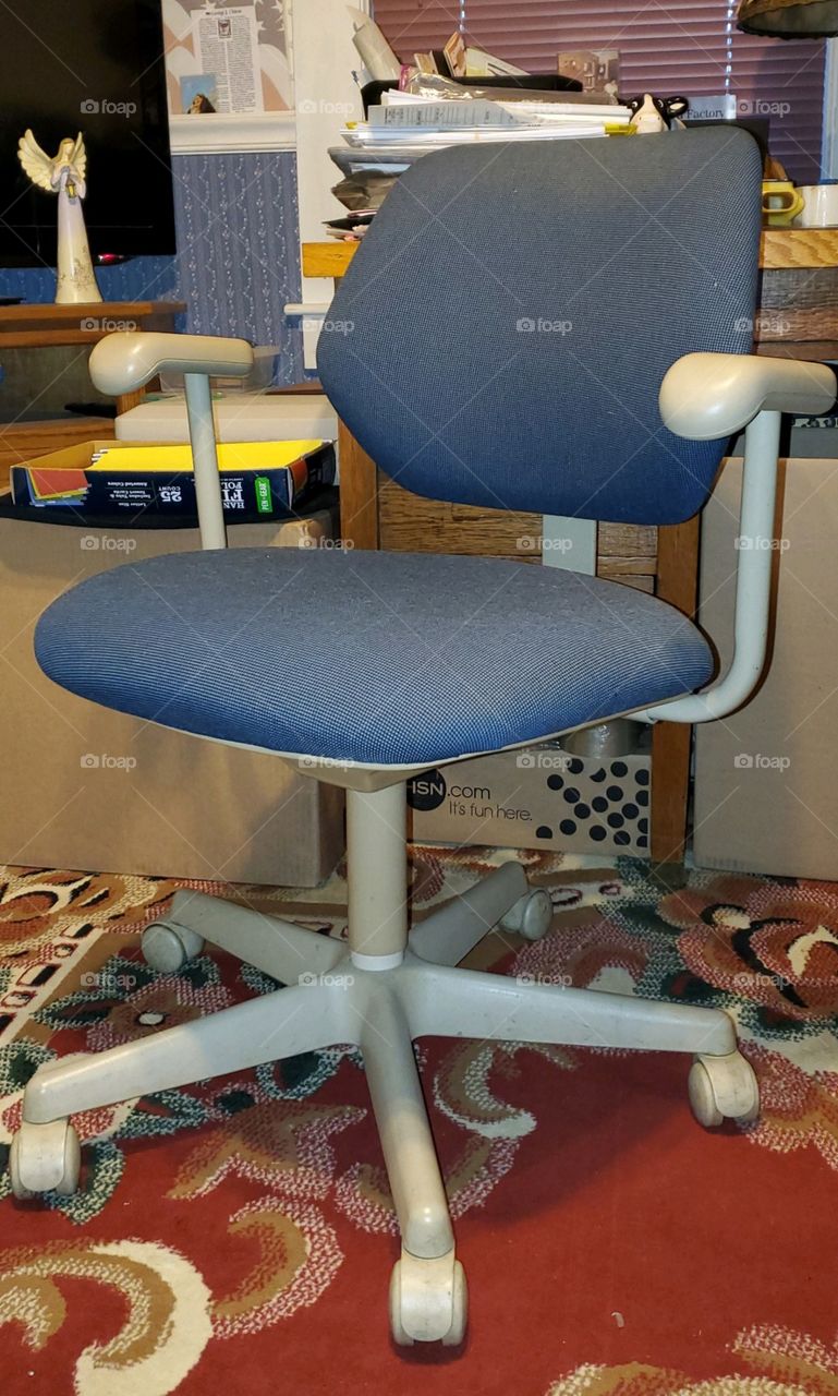 Blue office chair, 5 legs, in home office before donating it. Comfortable office chair with arm rests, adjustable for comfort especially for computer heights.