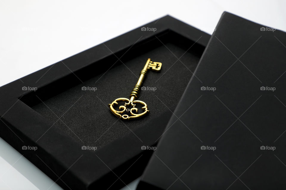 Golden antique key in a black box