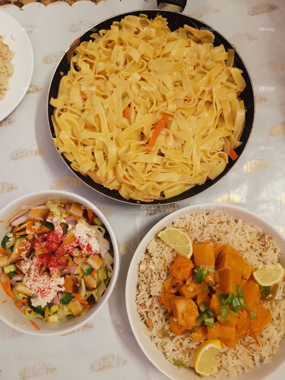 Pasta with cream, white sauce, rice with vegetables, chicken pieces, green salad with croutons